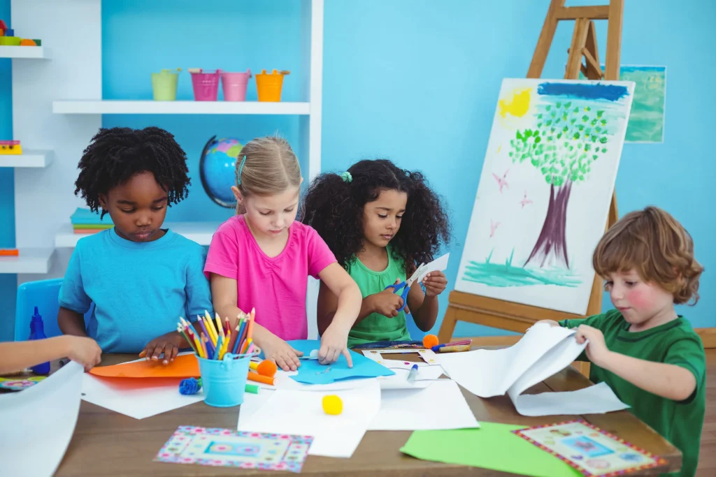 Students painting artwork during creative school art program